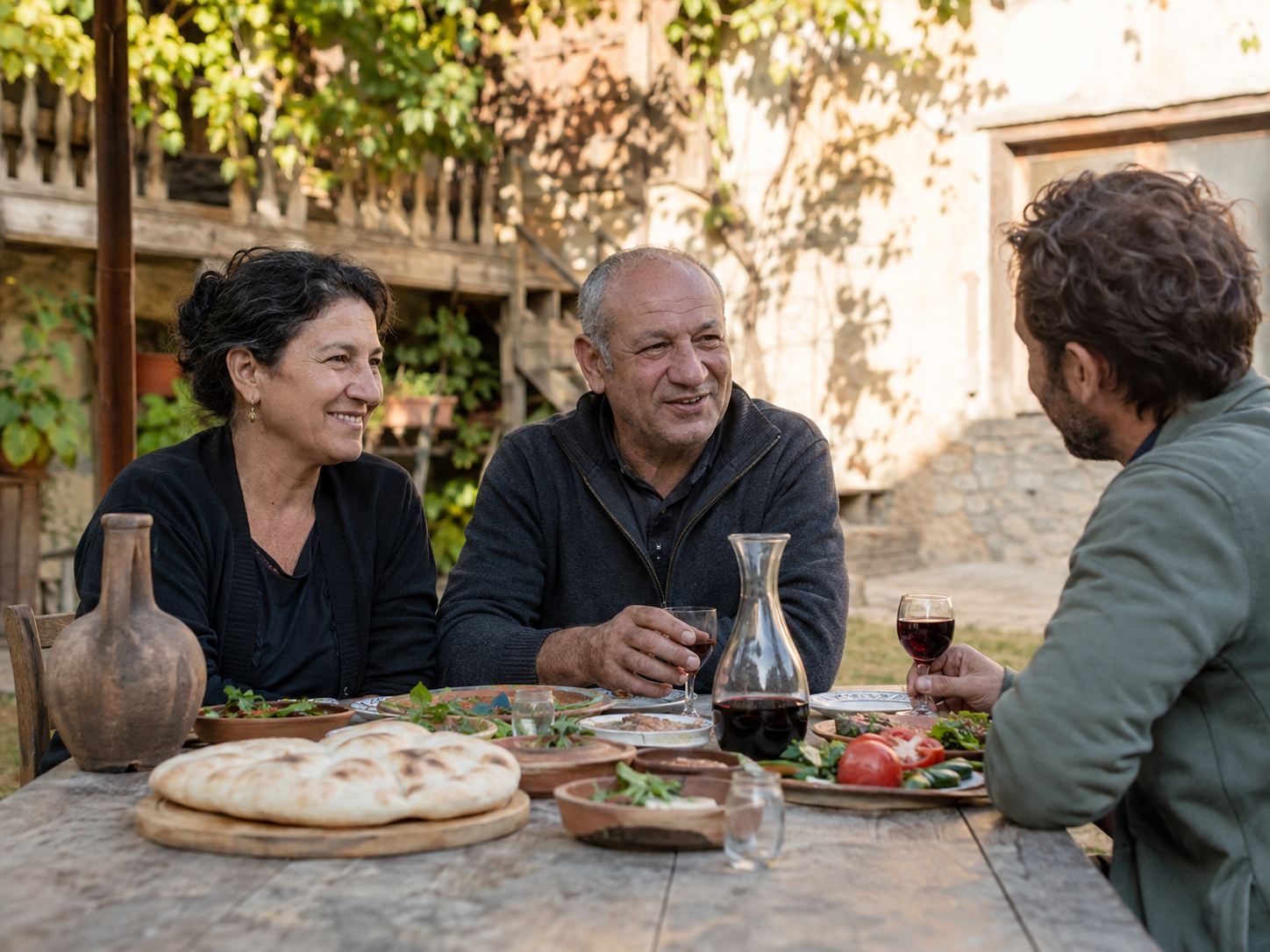 Nino and Giorgi welcoming guests at their Kakheti table